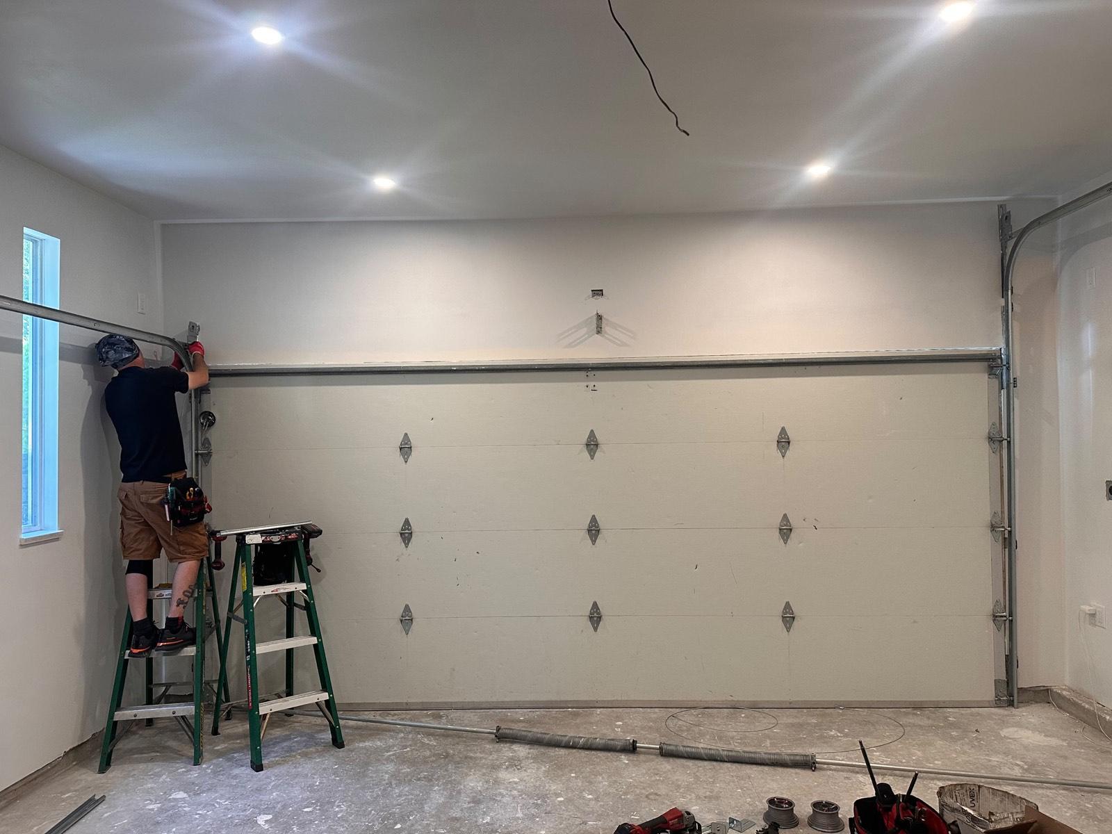 Technician completing a new garage door installation
