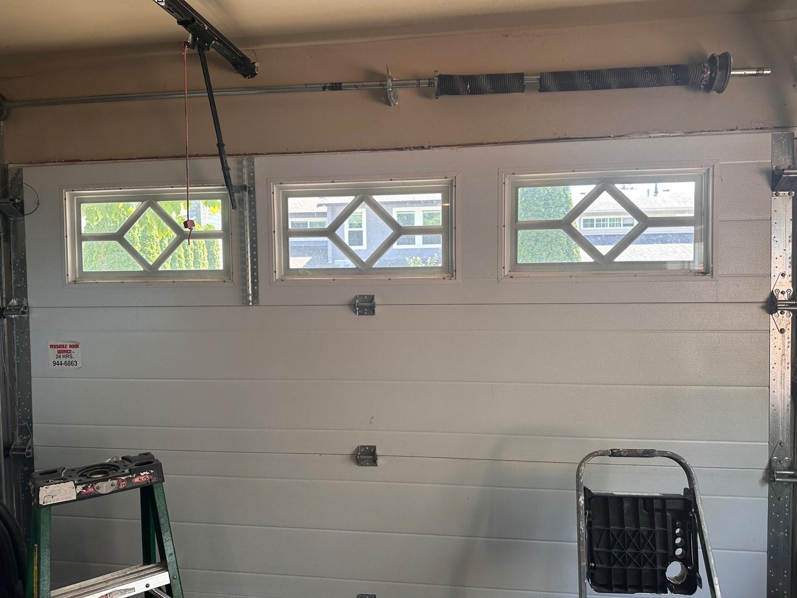 Newly installed residential garage door with decorative windows