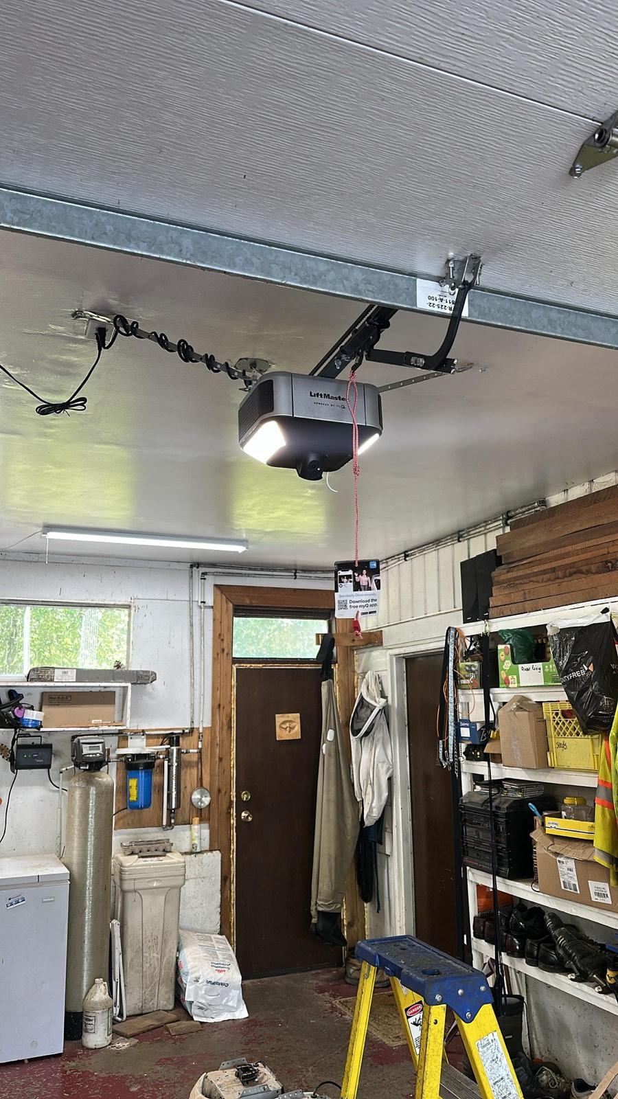 Newly installed garage door opener on a residential ceiling
